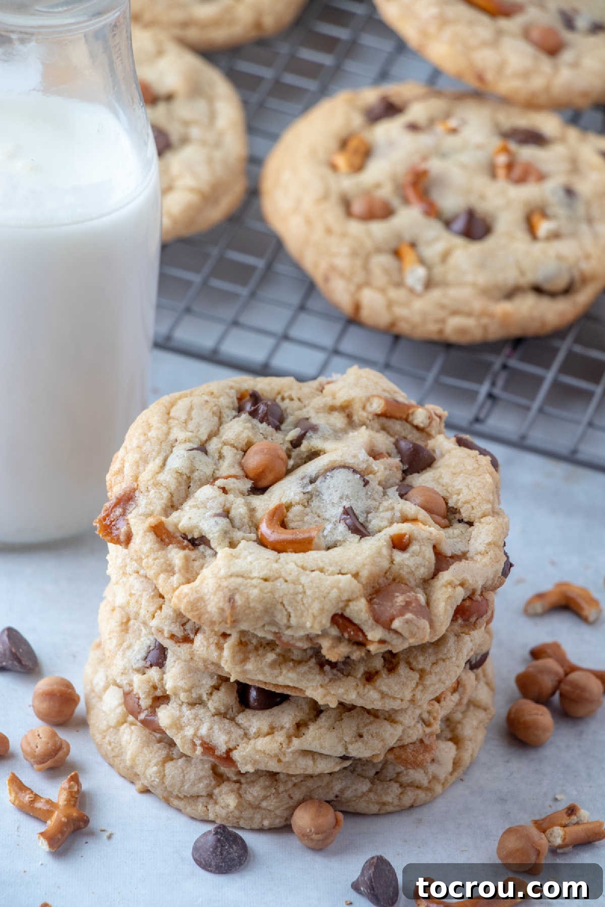 Stack of kitchen sink cookies in front of bottle of milk.