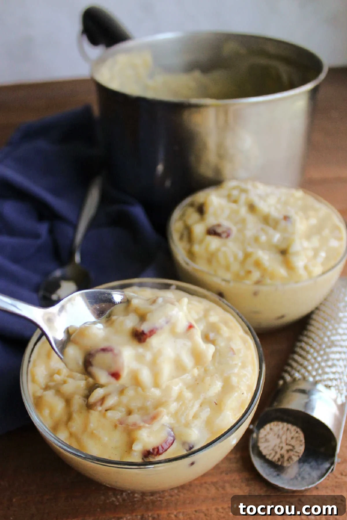 Spoonful of Rice Pudding Bite of creamy rice pudding on spoon, ready to eat.