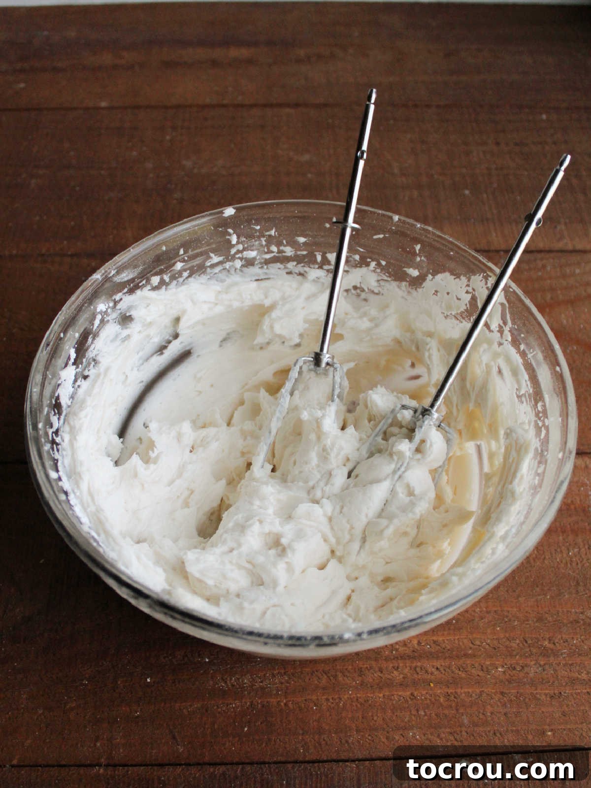 Mixing bowl with fluffy vanilla buttercream, ready to go on cupcakes.
