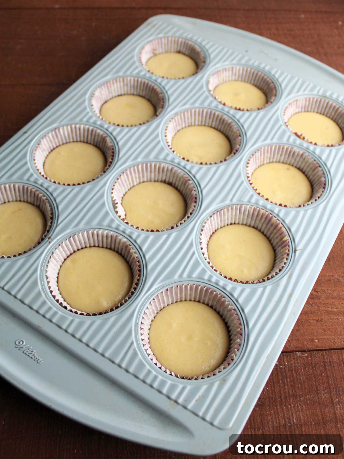Partially baked cupcake bases ready for filling.