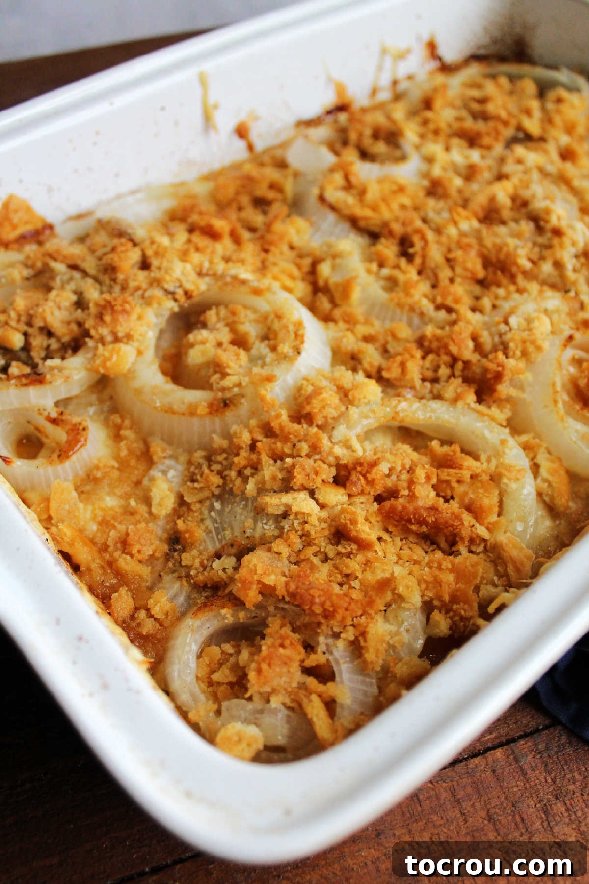 Close up of baked onion casserole, showing texture of the crackers and onions.