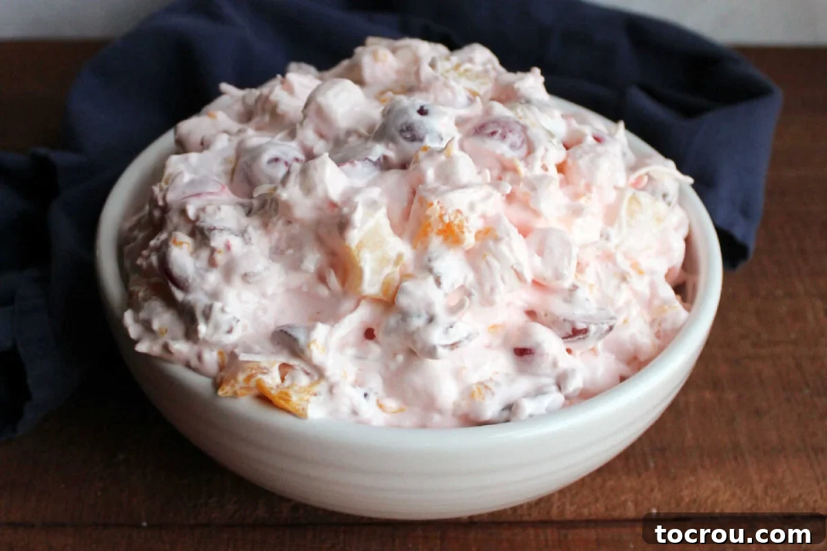 Divine Ambrosia Medley 2 White serving bowl filled with creamy ambrosia fruit salad, ready to be served.