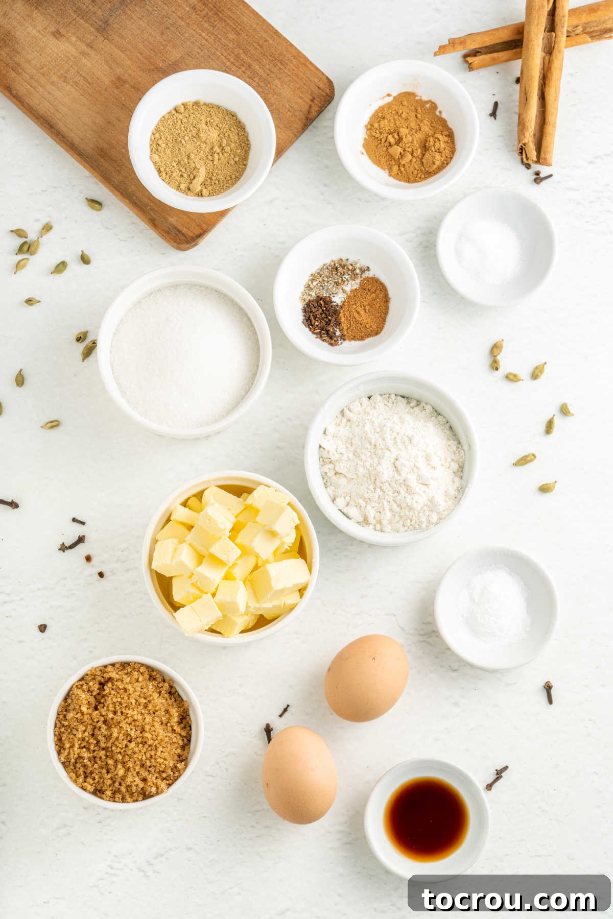 Chai cookie ingredients including butter, eggs, flour, vanilla, cinnamon, and other spices ready to be made into cookie dough.