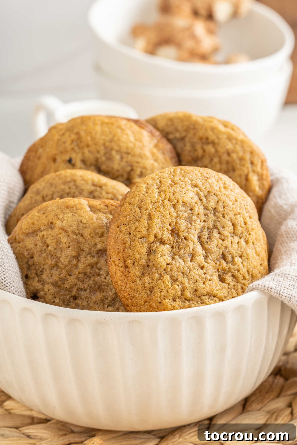 White bowl filled with large chai spiced cookies.