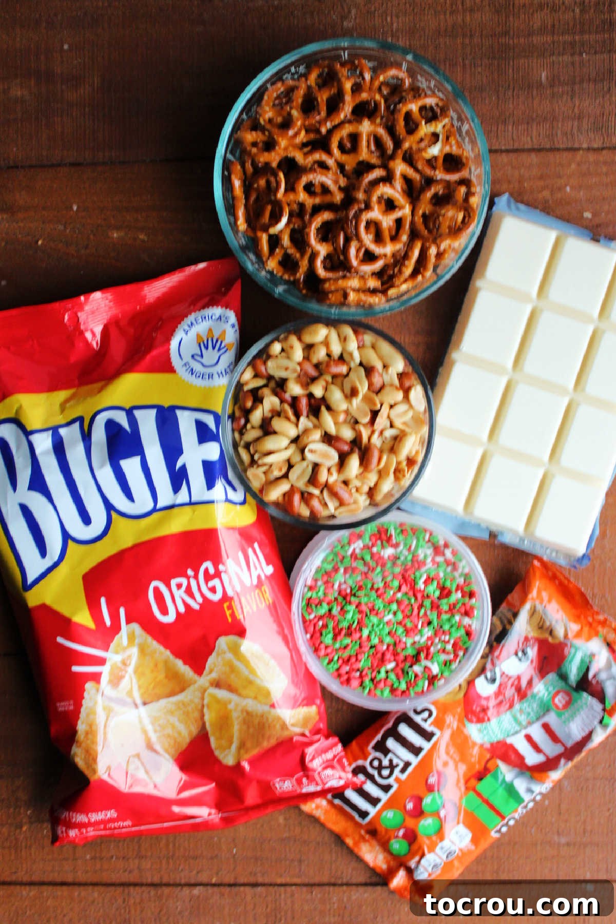 Ingredients: bugles, pretzels, peanuts, sprinkles, almond bark, sprinkles and m&ms ready to be made into snack mix.