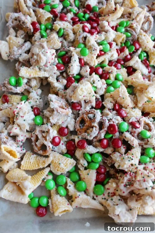 sweet and salty snack mix tossed in white chocolate with red and green candies .