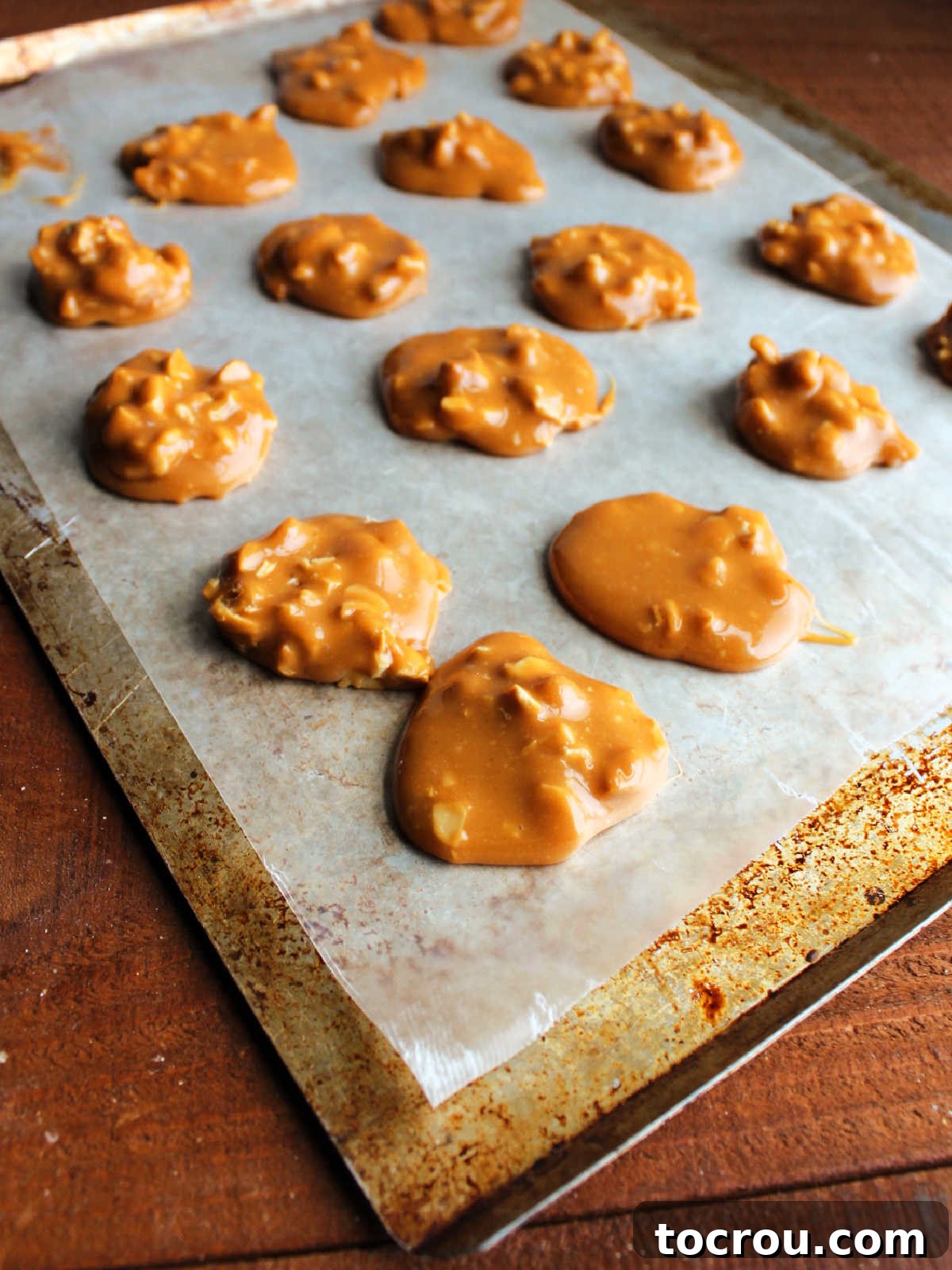 Chilled Caramel Cashew Centers Caramel and cashew centers setting up on wax paper ready to be dipped in chocolate.