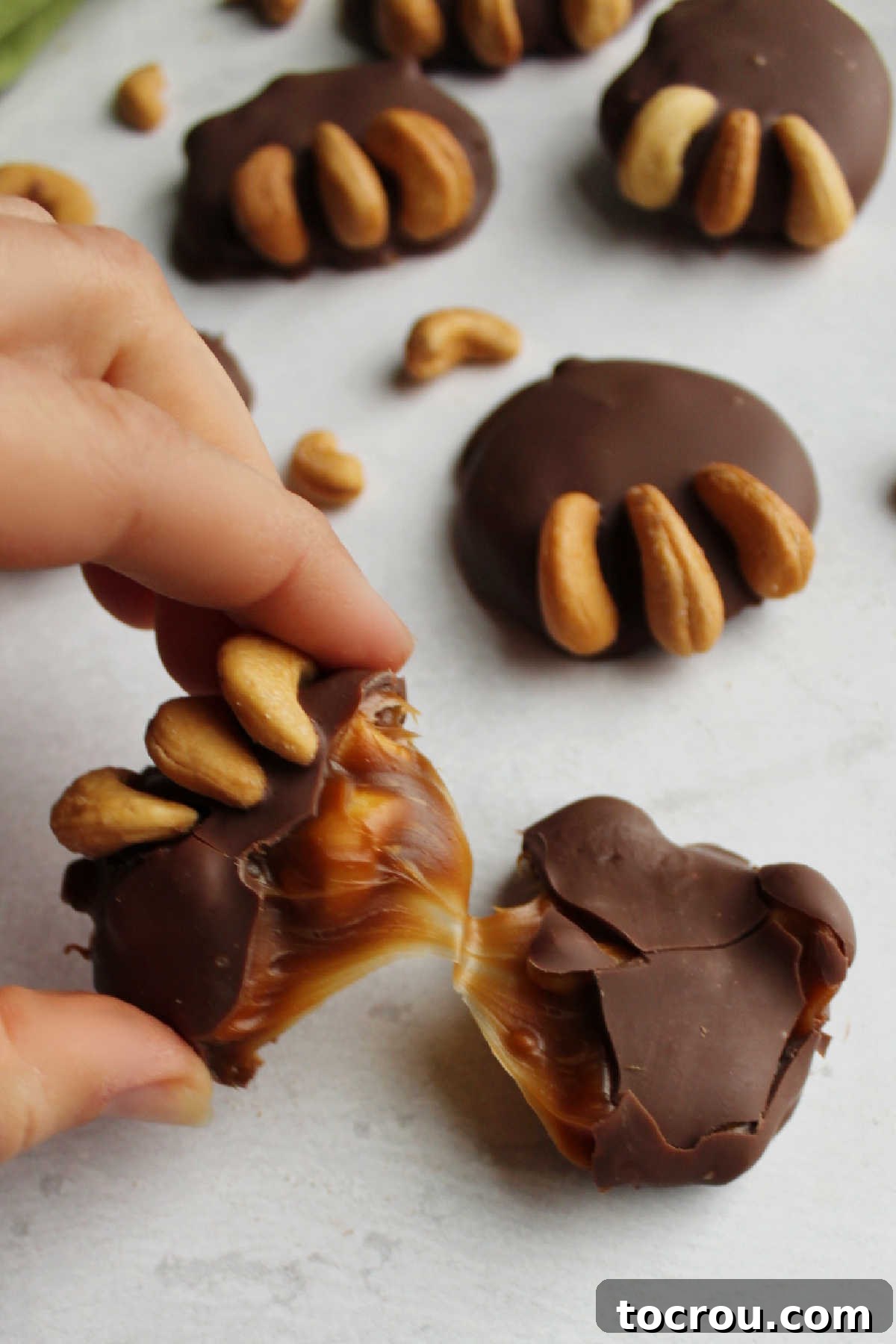 Soft Caramel Center Pulling soft caramel center in broken cashew bear paw candy.