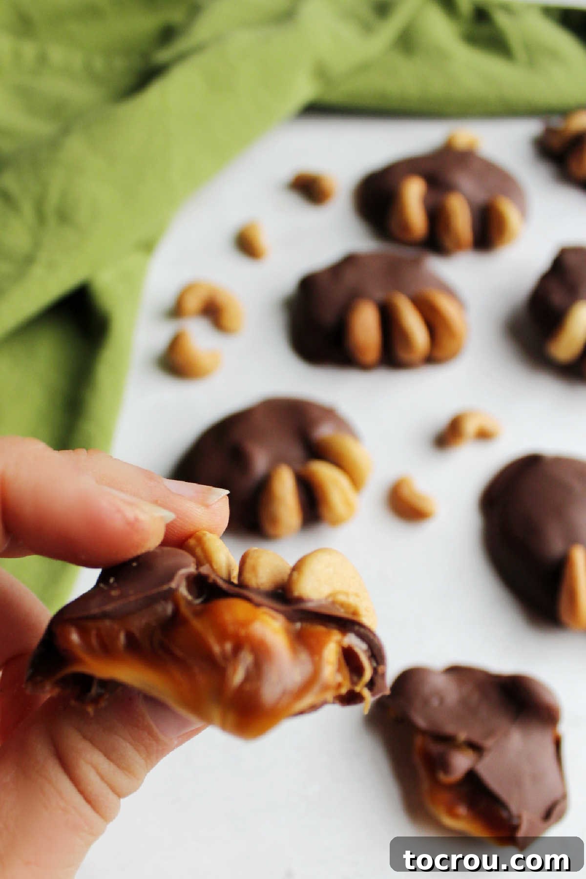 Enjoying a Bear Claw Candy Hand holding bear paw candy with soft caramel center showing.