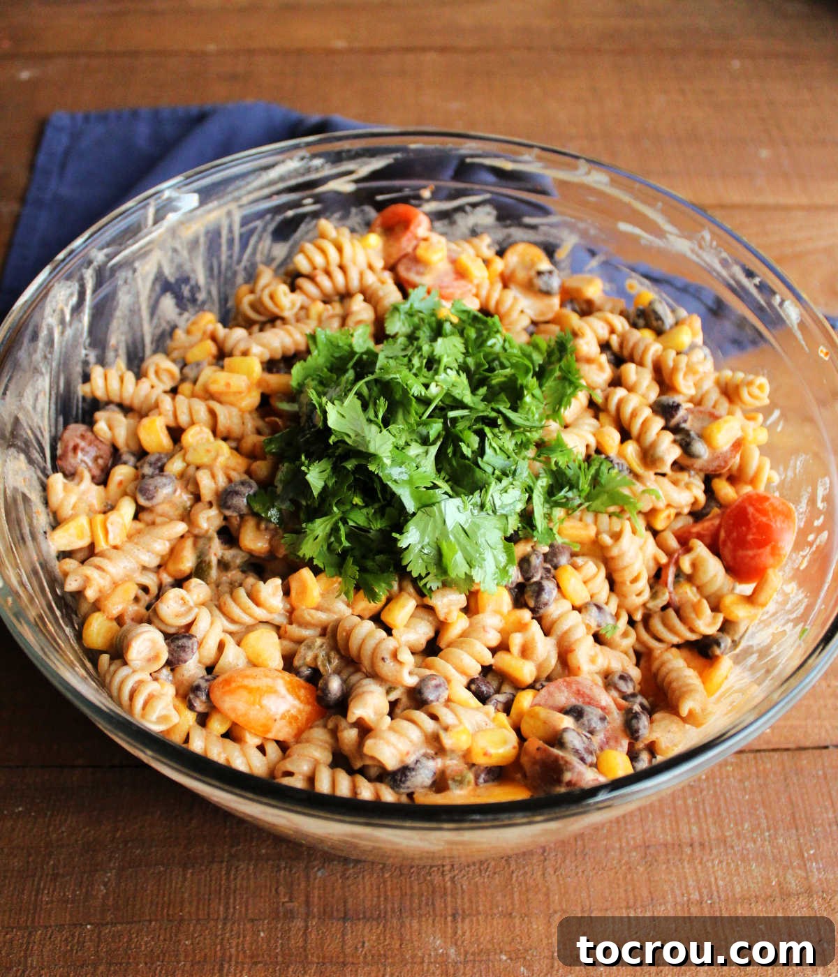 Fresh Cilantro for Garnish A small bowl of freshly chopped cilantro, ready to be sprinkled into the chilled pasta salad, adding a burst of fresh flavor and vibrant green color.