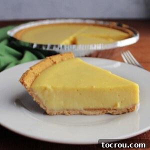 Side view of slice of key lime pie showing smooth and creamy filling.