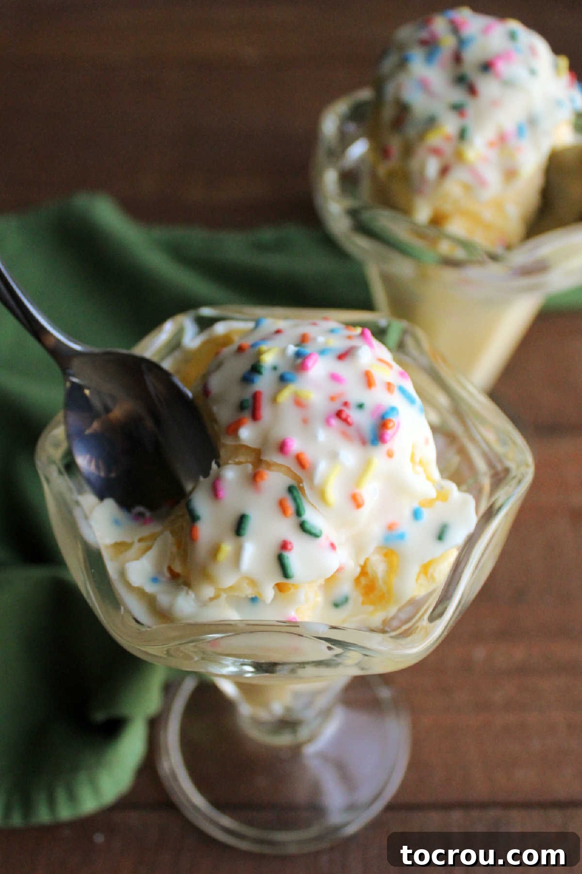 DIY Unicorn Rainbow Glaze 3 Spoon cracking through unicorn magic shell that has hardened over ice cream.