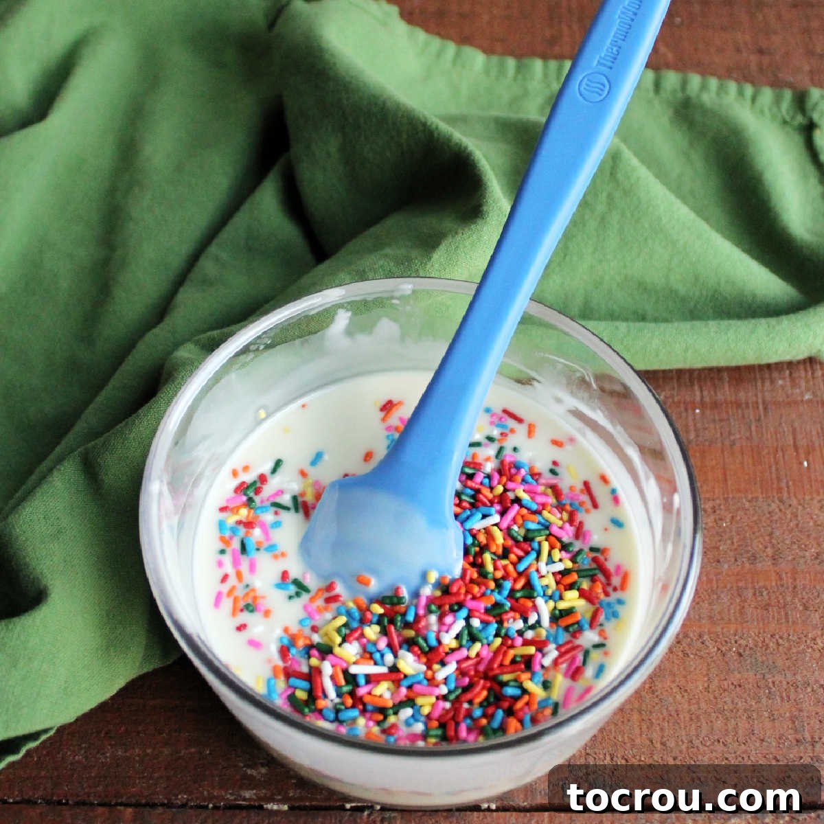 DIY Unicorn Rainbow Glaze 7 Adding colorful jimmies to white chocolate magic shell to make unicorn magic shell.