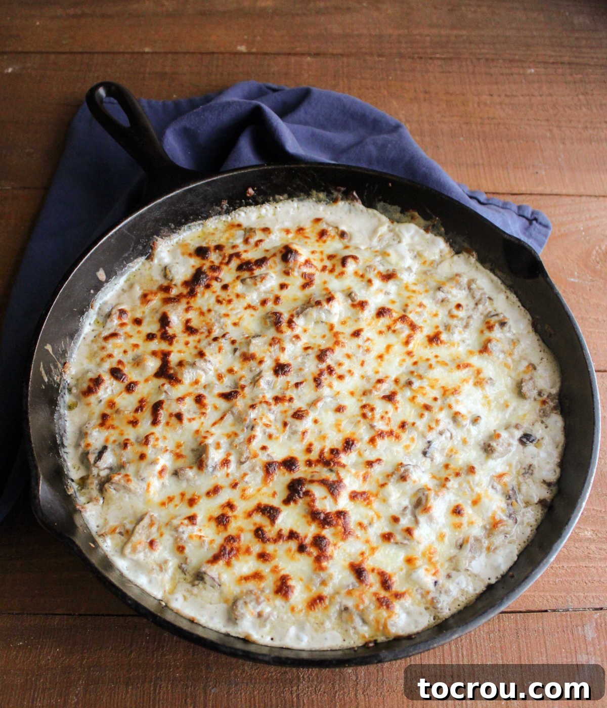 Creamy Baked Sausage Mushroom Dip 8 A baked cast iron skillet of golden-brown stuffed mushroom dip, with melted and slightly crispy cheese topping, fresh from the oven and perfectly bubbly.