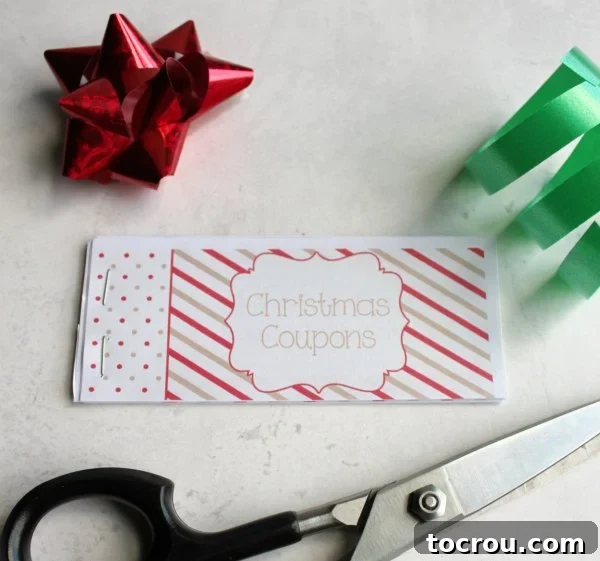 Enjoy the magic of Christmas and make memories with your favorite kiddos by printing this free coupon book and enjoying the activities. You can have your coupon book put together in just a couple of minutes and have memories that will last a lifetime! Assembled coupon book with scissors and a bows.