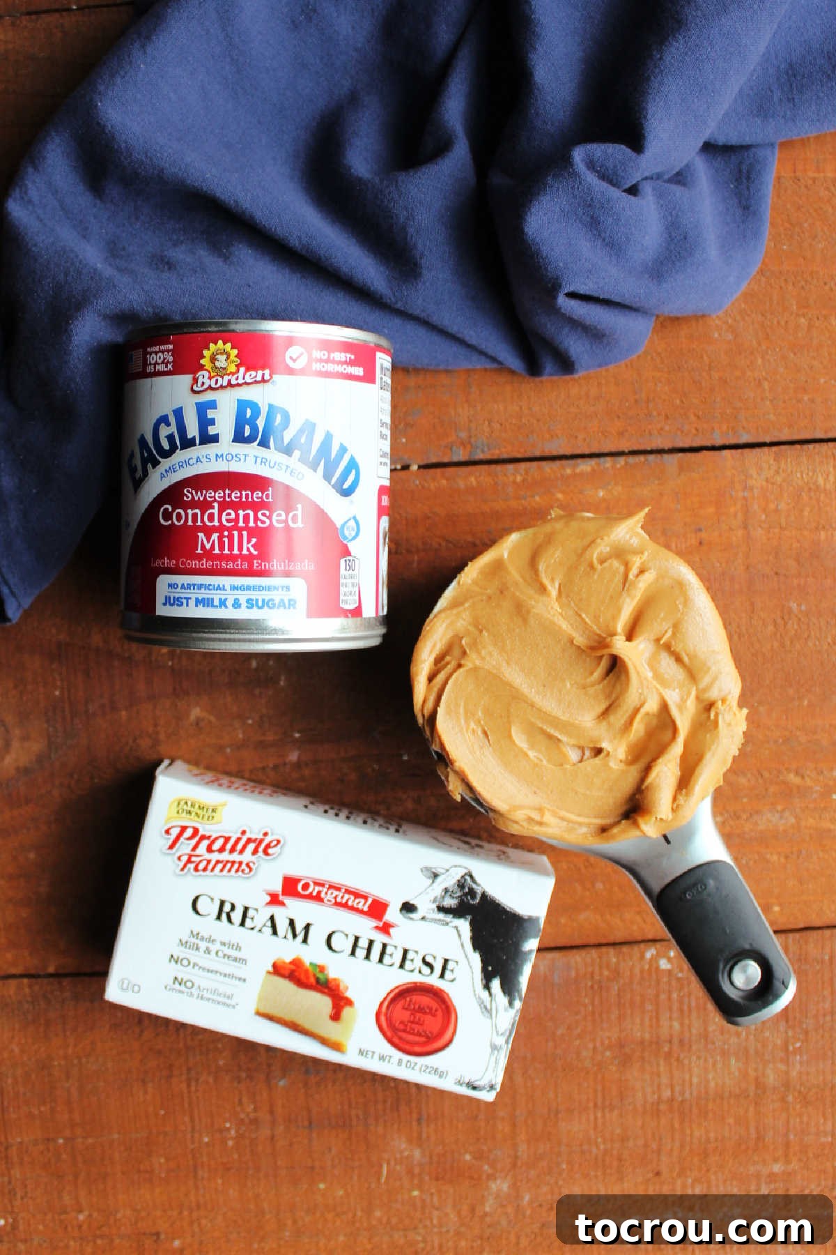 Ingredients including cream cheese, sweetened condensed milk, and peanut butter, ready to be made into peanut butter cream cheese frosting. 