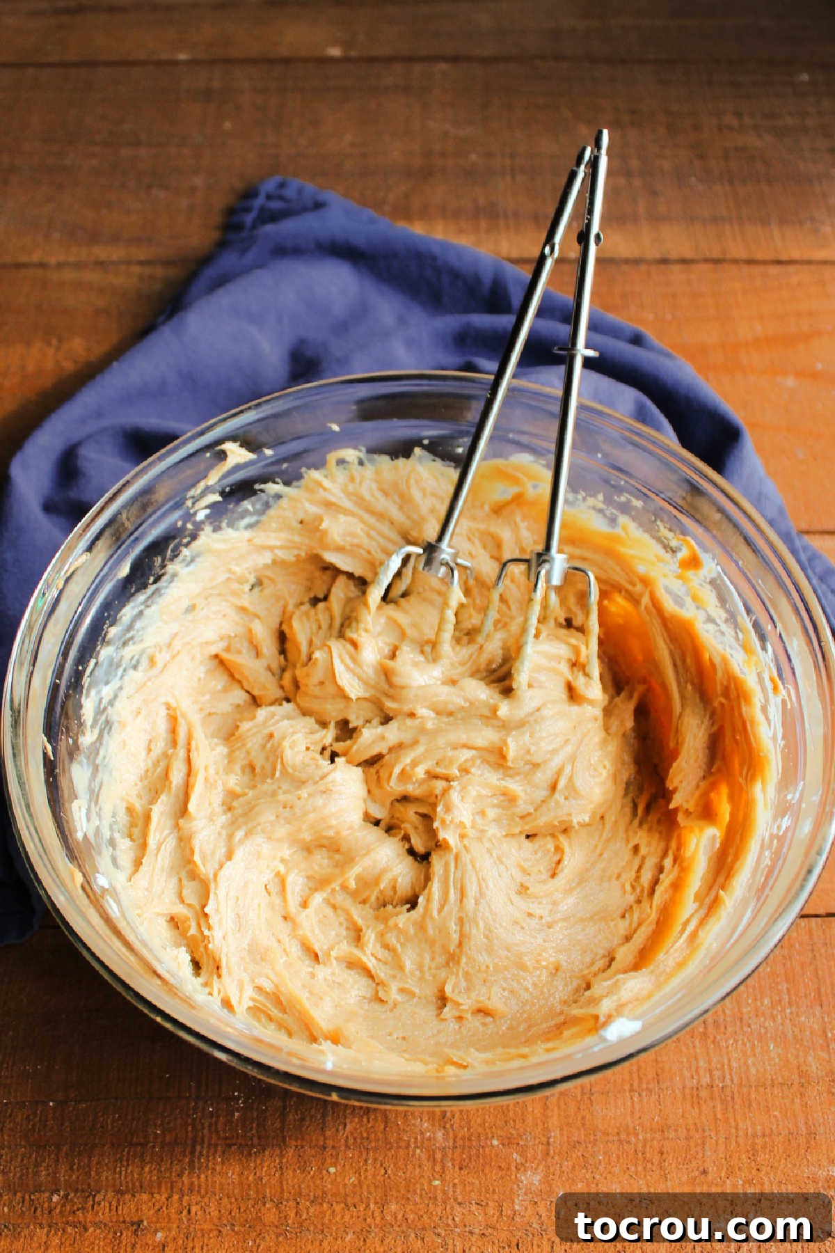 Mixing bowl filled with creamy peanut butter cream cheese frosting.