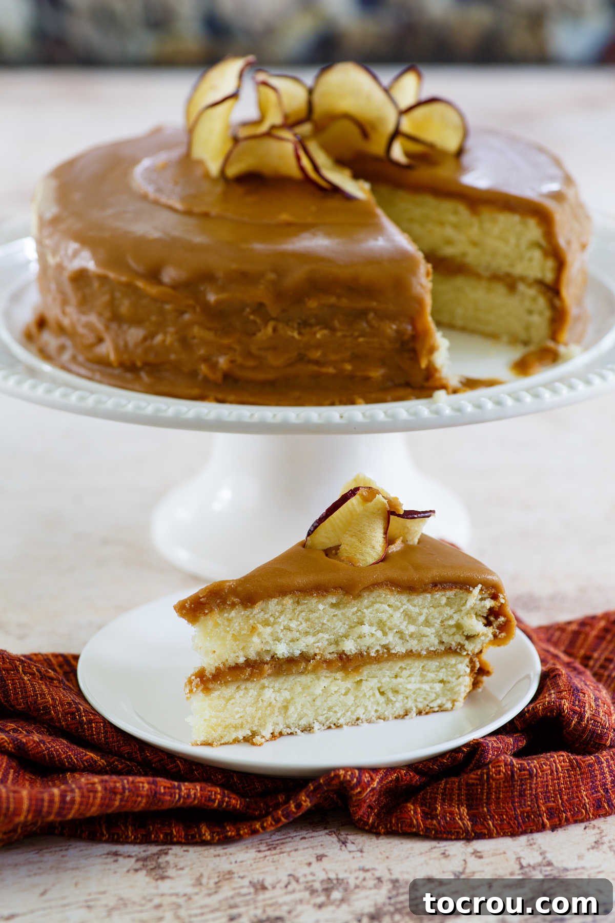 A delectable slice of homemade Southern style caramel cake, showcasing the moist cake layers and generous homemade caramel frosting.