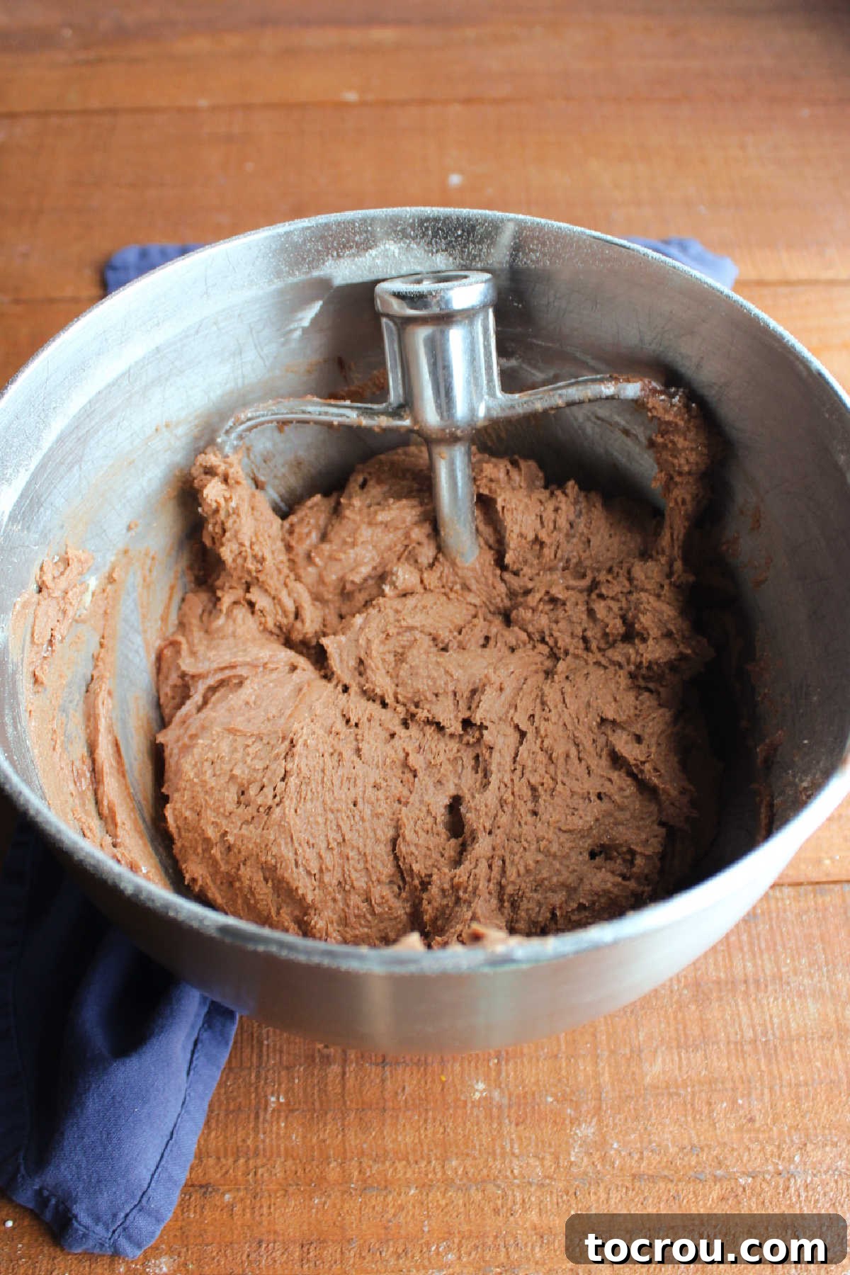 Mixer bowl filled with rich chocolate cookie dough, ready for chilling.