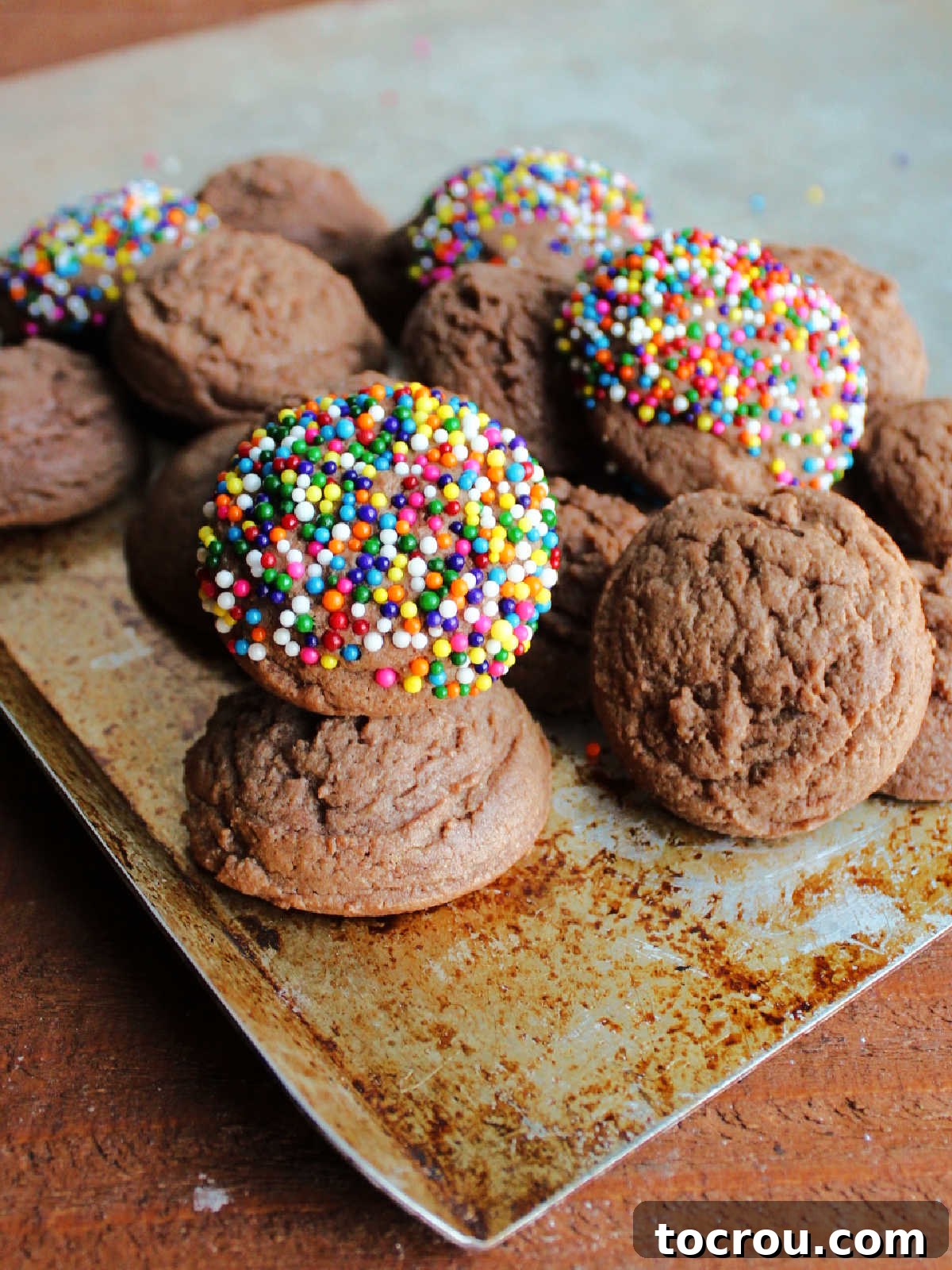 A generous pile of chocolate condensed milk cookies on a baking pan, ready to be devoured.