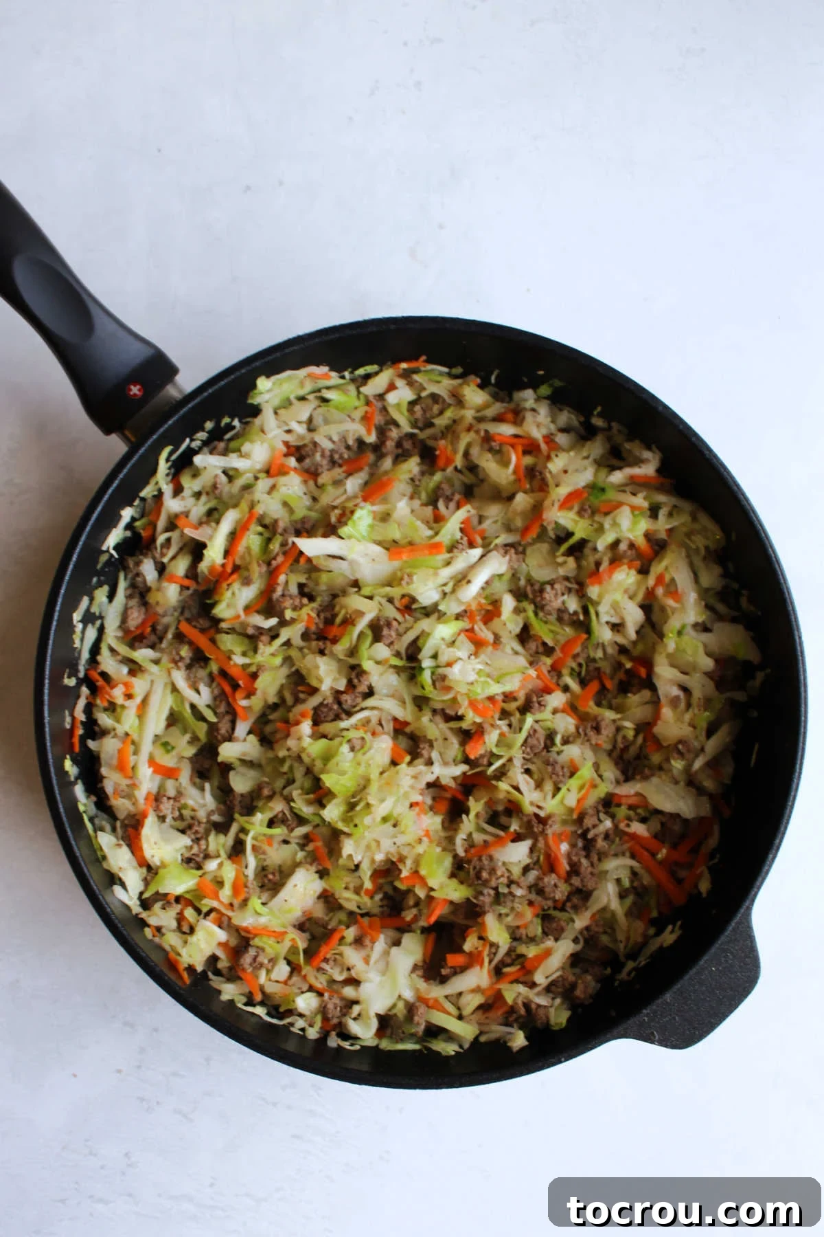 cooked beef and cabbage filling in saute pan for beirocks.