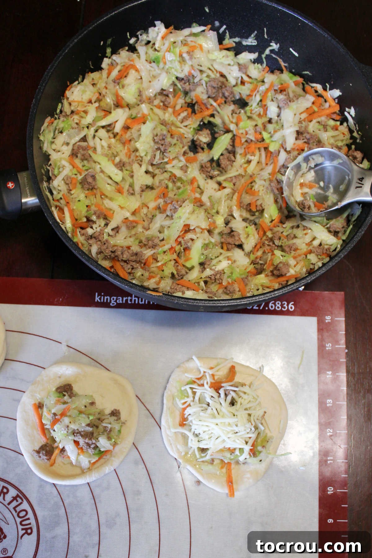 putting shredded cabbage and ground beef cabbage on flattened dough circles for runzas.