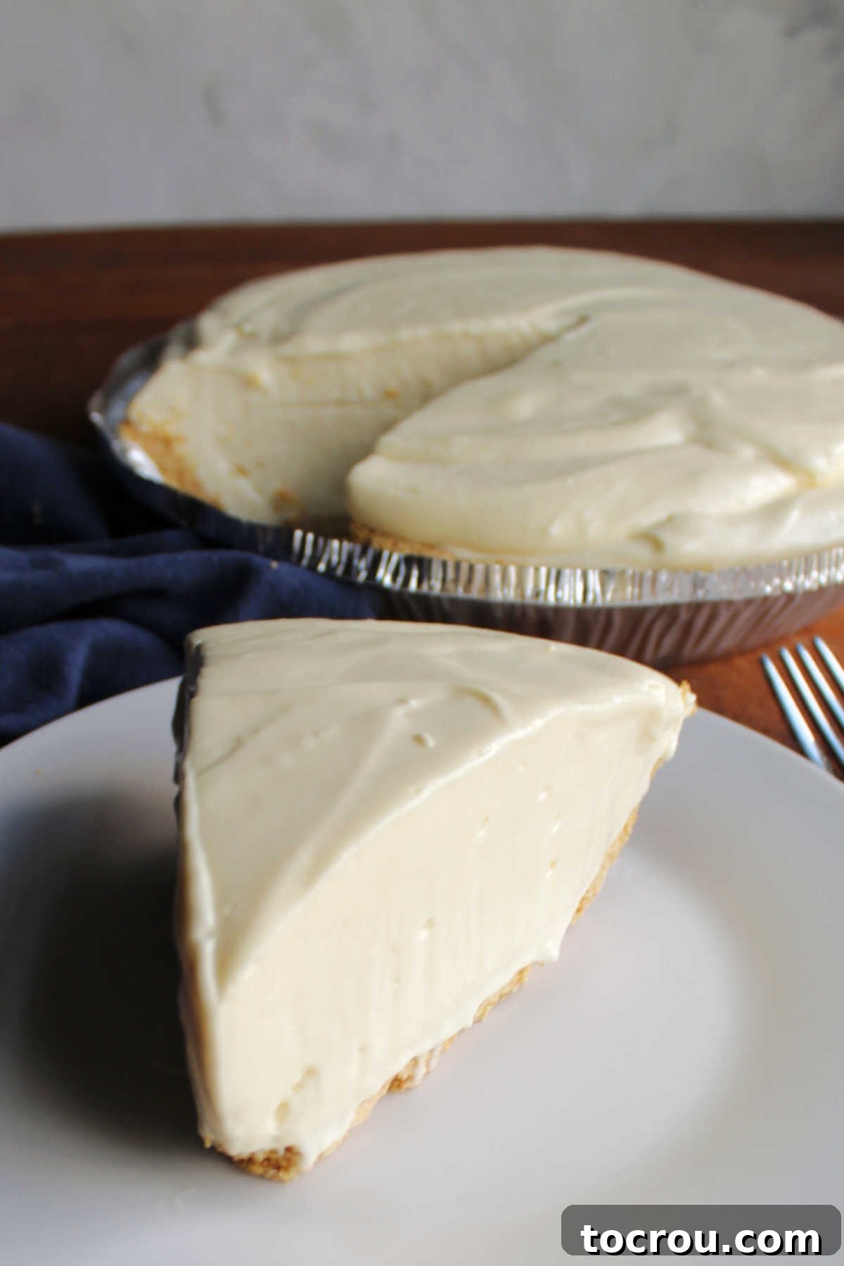 Piece of orange no bake pie on desert plate.