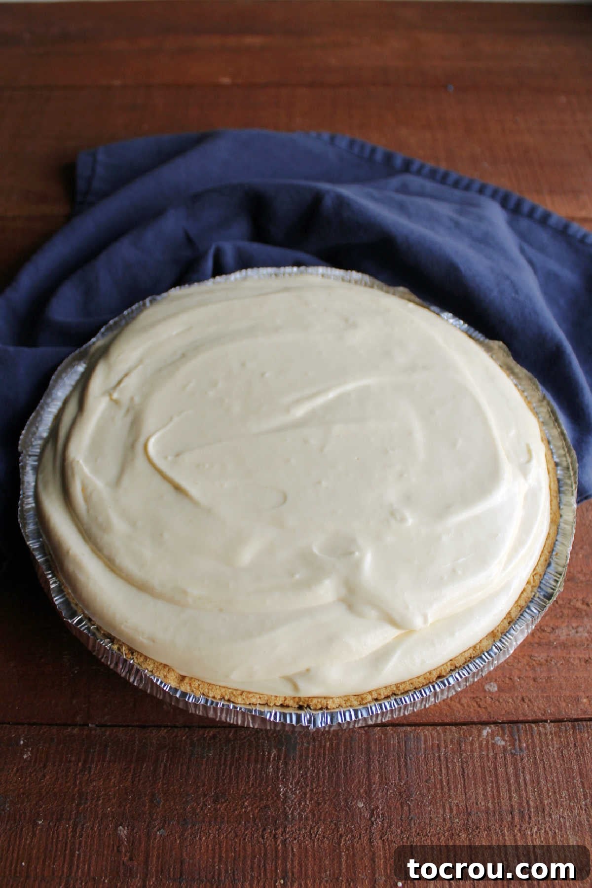 Fluffy orange no bake pie piled high with extra filling.