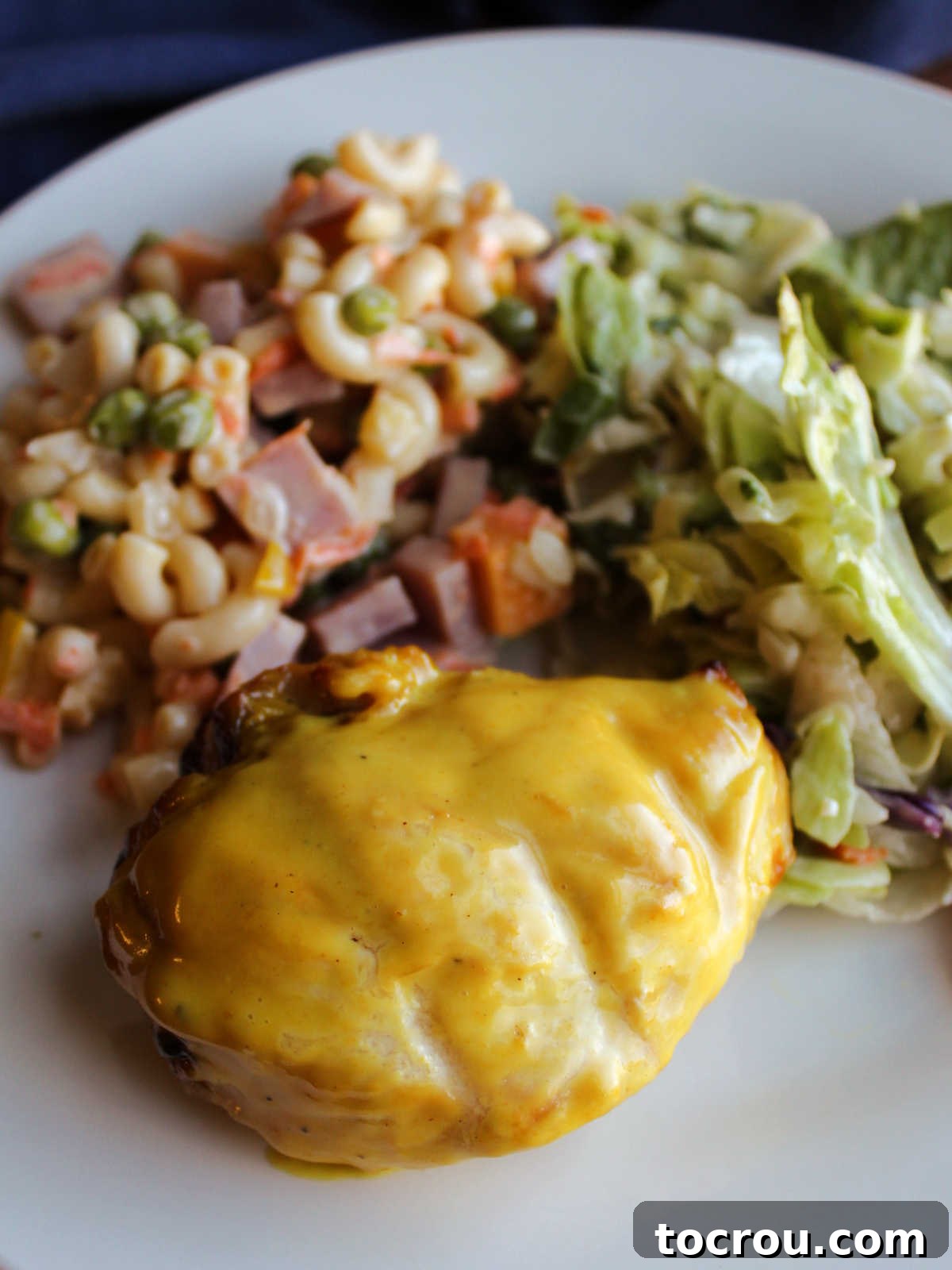 Tracy's Golden Hen 3 Yellow chicken freshly brushed with mustard ranch sauce served with salad and pasta salad.