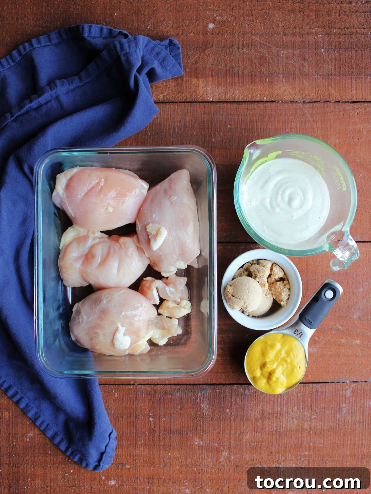 Tracy's Golden Hen 4 Ingredients including raw boneless skinless chicken breasts, ranch dressing, brown sugar, and mustard ready to be made into yellow chicken.