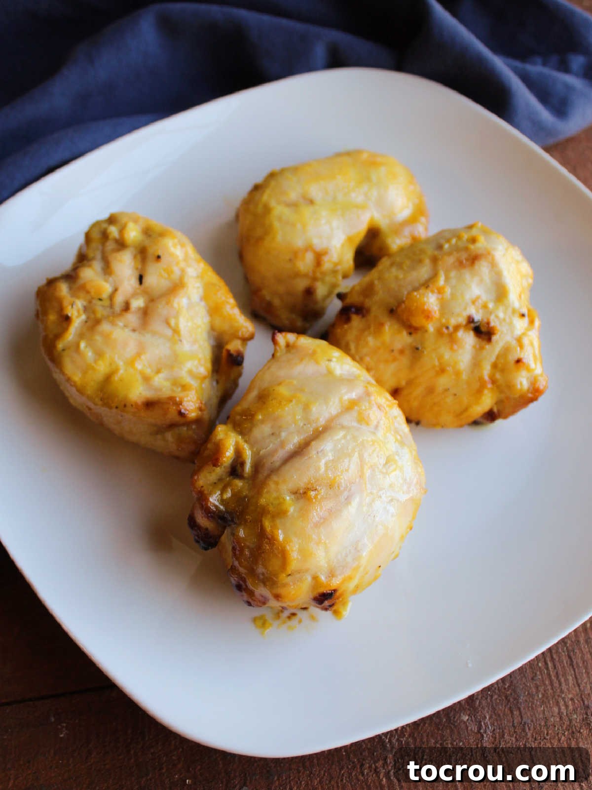 Tracy's Golden Hen 8 Plate of cooked yellow chicken with mustard ranch sauce, ready to be served.