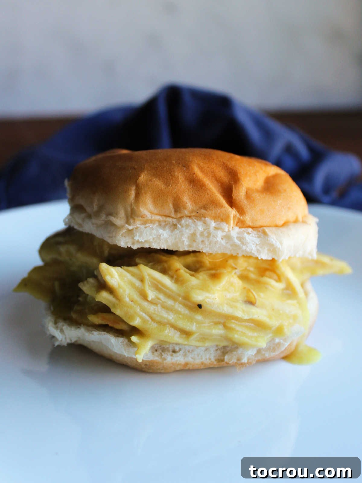 Tracy's Golden Hen 9 Slow cooked yellow chicken with ranch mustard sauce served on hamburger bun.