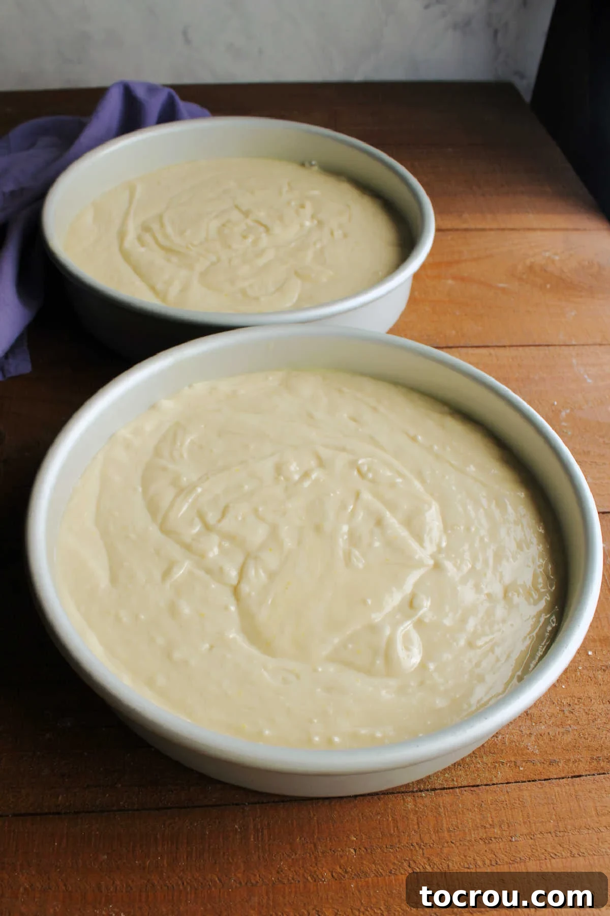 The 10-Inch Vanilla Classic 9 Cake batter in prepared 10 inch round cake pans, ready to go in the oven.