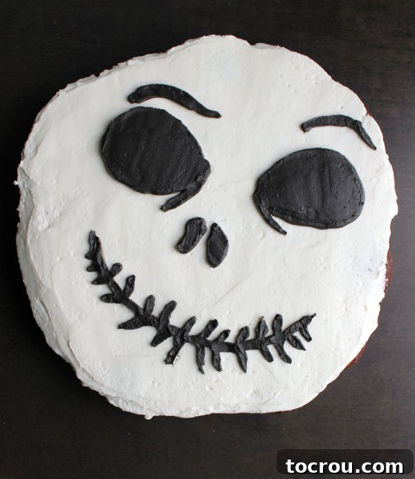 Jack Skellington cupcake cake with solid white frosting background and black face formed over a base of chocolate cupcakes, ready to be pulled apart and eaten.
