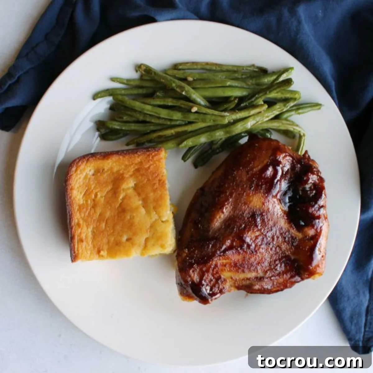 Perfect Oven Baked BBQ Chicken Dinner dinner plate with oven baked bbq chicken breast roasted green beans and corn casserole.