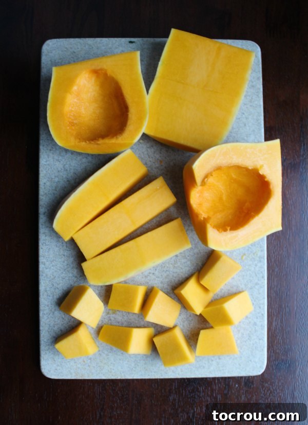 Crispy Air Fryer Butternut Squash 2 cutting board full of butternut squash pieces in various stages of being cleaned, peeled and diced.