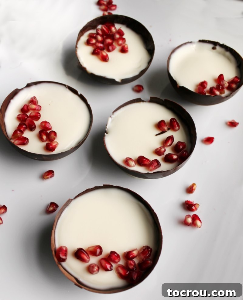Panna Cotta in Chocolate Bowls with Pomegranate dark chocolate bowls filled with yogurt panna cotta and sprinkled with pomegranate seeds.