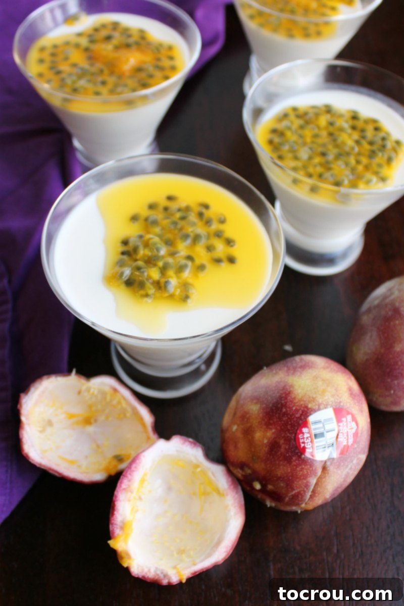 Vanilla Panna Cotta with Passion Fruit Topping Looking down on passion fruit topped vanilla yogurt panna cotta with empty passion fruit shell and some fresh passion fruit nearby.