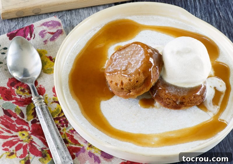 Individual sized baby sweet potato cakes served with a scoop of ice cream and drizzle of sticky caramel sauce are a perfect fall dessert. They are cozy, flavorful and sure to become a favorite treat. A beautifully arranged plate featuring two mini sweet potato cakes, a dollop of melting vanilla ice cream, and a generous pour of sticky caramel sauce, ready for a delightful indulgence.