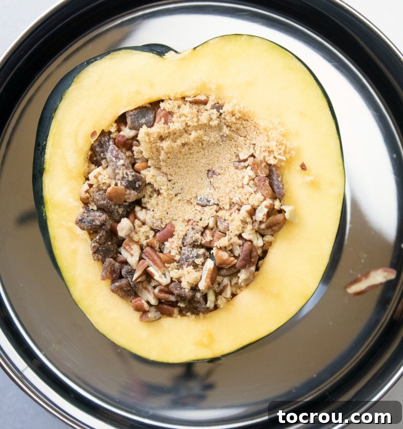 Acorn squash half generously filled with a mixture of crunchy pecans, chewy dates, and rich brown sugar.