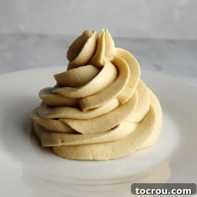 Swirl of brown sugar buttercream made with a custard base in the style of german frosting.