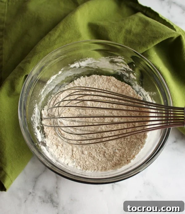 brown sugar, corn starch and whisk in glass bowl for german buttercream