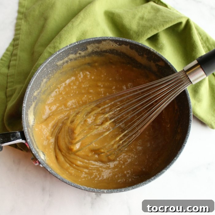 lumpy brown sugar custard mixture in saucepan for german buttercream