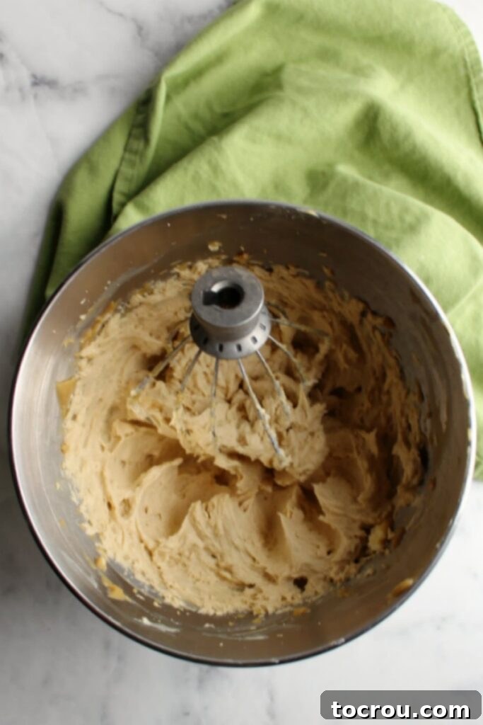 stand mixer bowl full of brown sugar German buttercream freshly whipped together