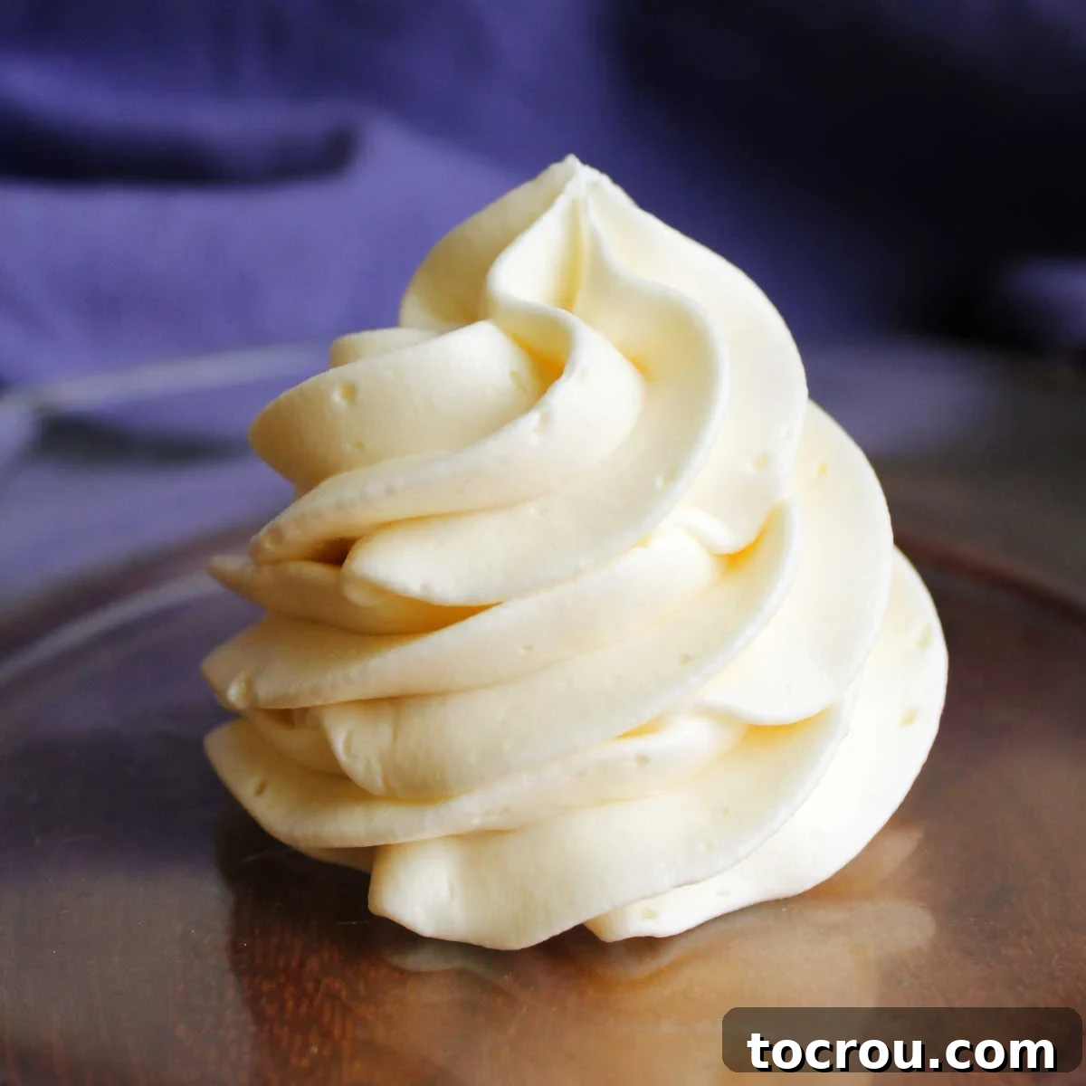 A beautifully piped swirl of smooth and creamy Russian buttercream frosting, showcasing its delightful texture and appealing finish, ready to adorn any dessert.
