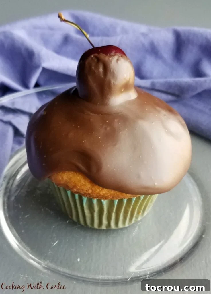 close up of chocolate topped cherry cupcake.
