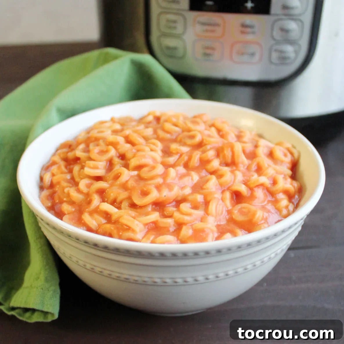 Homemade Instant Pot Spaghettios: A Nostalgic, Easy, and Delicious Copycat Recipe A vibrant bowl filled with homemade Instant Pot Spaghettios, sitting invitingly in front of a sleek Instant Pot, ready to evoke childhood memories with every spoonful.