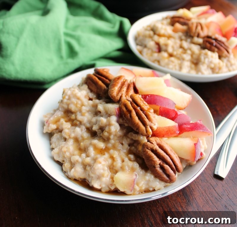 Close up of bowl of maple cinnamon steel cut oats with pecans and fresh peaches on top.