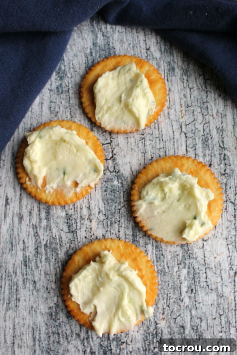Havarti cheese ball mixture spread over crackers.