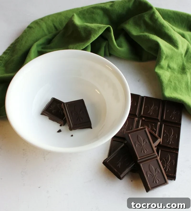 Decadent Black Forest Sheet Cake 7 Dark chocolate pieces in a bowl, ready to be melted and transformed into ganache.